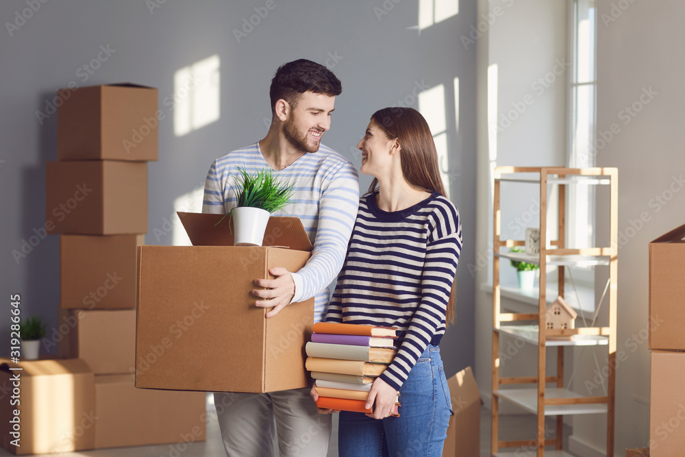 Young couple family with boxes to move in a new house room. Young couple family with boxes to move in a new house room.