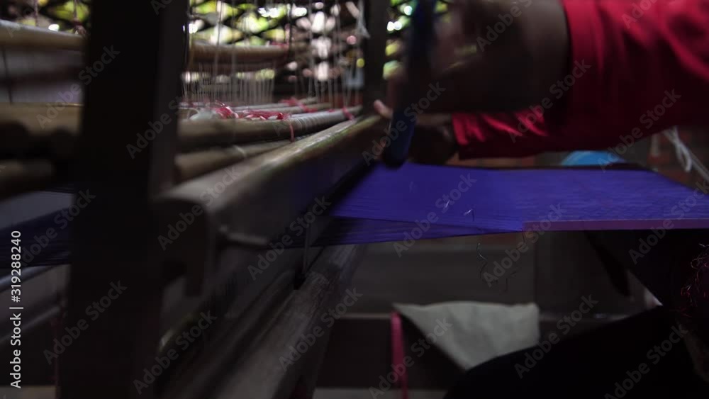 Woman weaving handmade silk clothes. Making silk by hand with traditional tools. Handloom industry. Woman weaving handmade silk clothes. Making silk by hand with traditional tools. Handloom industry.