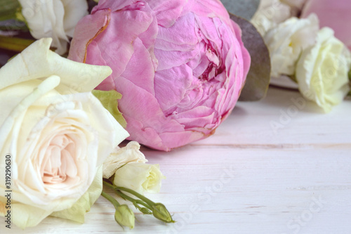 Delicate romantic bouquet for a gift. Huge pink peonies and white roses on a white background. Flower arrangement for Valentine's Day, Mother's Day or International Women's Day.