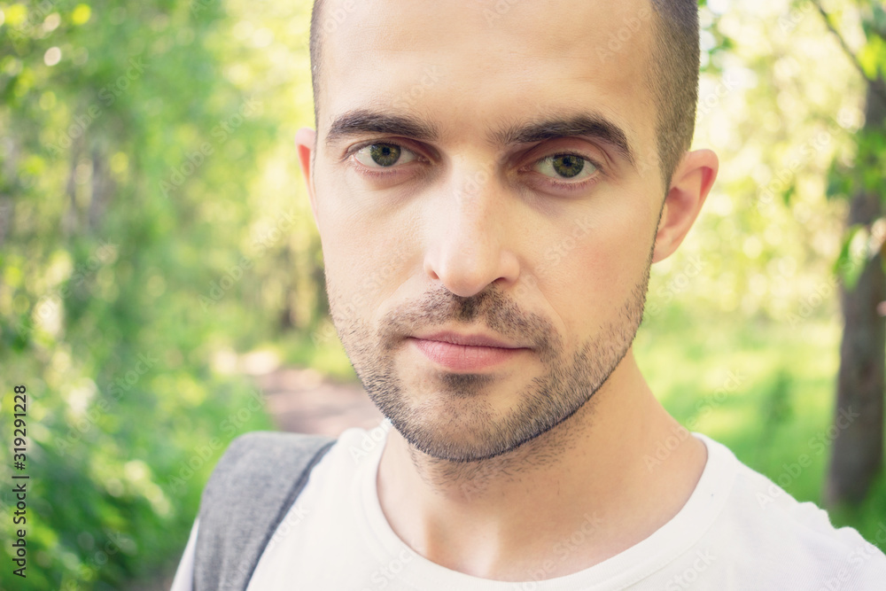 Male looking at the camera, man standing in the woods, portrait, toned Male looking at the camera, man standing in the woods, portrait, toned