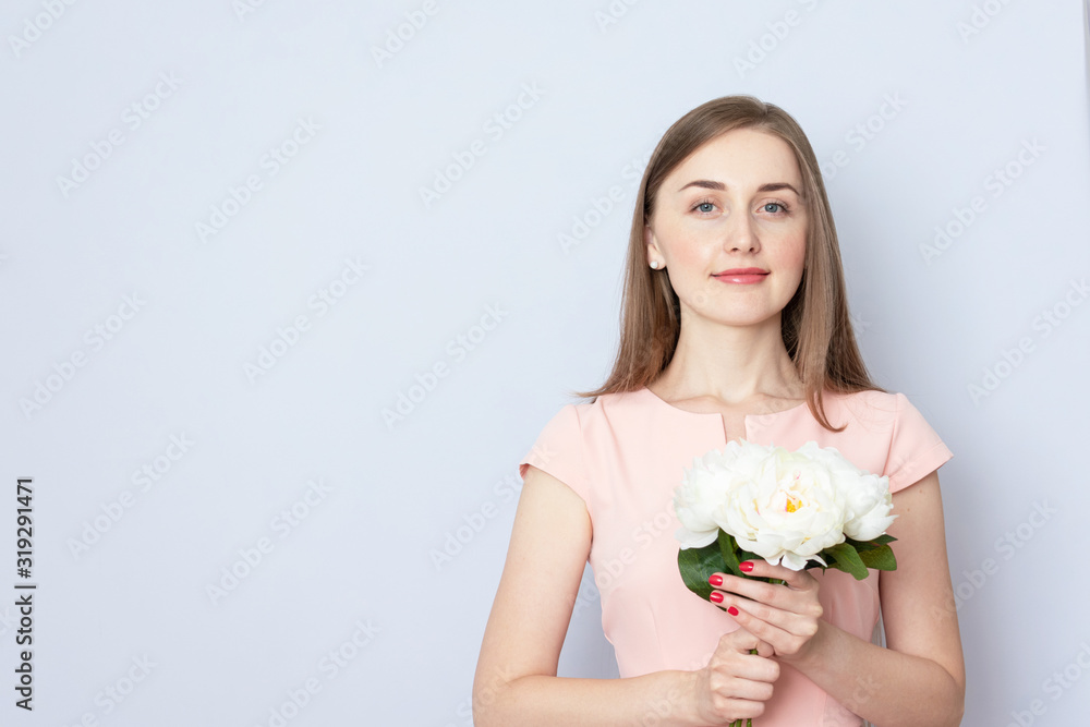 Young girl with white peonies, grey background, portrait, toned Young girl with white peonies, grey background, portrait, toned