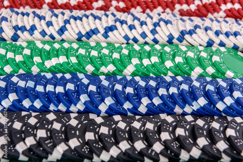 Colorful poker chips in rows close up as background. Gambling concept