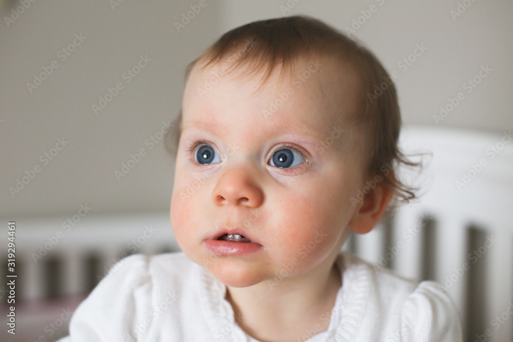 Close up Portrait of 10 Month Old Cute Baby Girl  with big Blue Eyes