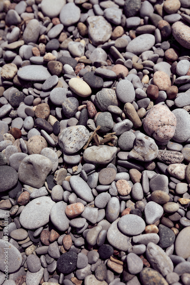 Photograph of natural rounded stones on a beach shot straight on. Good for use as a relaxing background or backdrop for any application. Photograph of natural rounded stones on a beach shot straight on. Good for use as a relaxing background or backdrop for any application.