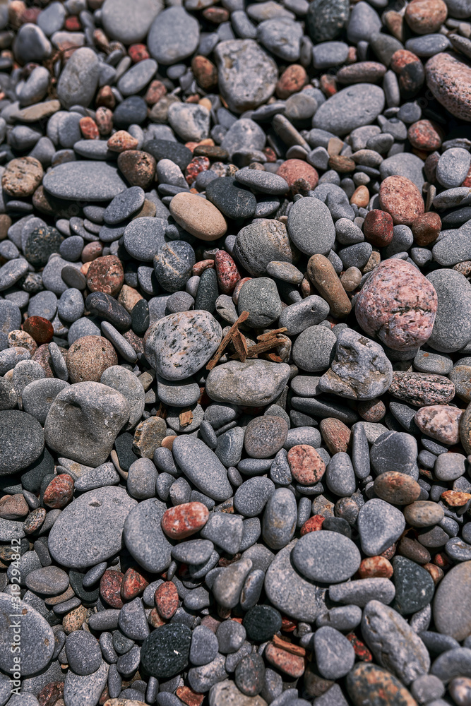 Photograph of natural rounded stones on a beach shot straight on. Good for use as a relaxing background or backdrop for any application. Photograph of natural rounded stones on a beach shot straight on. Good for use as a relaxing background or backdrop for any application.