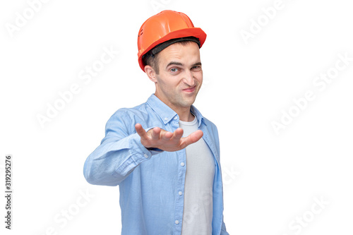 Wallpaper Mural Builder in a helmet shows the so-so gesture, isolated background, toned Torontodigital.ca