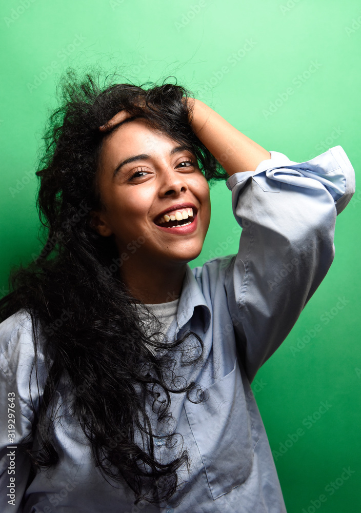 Spectacular middle eastern young woman with her black hair. Indoor photo of wonderful female model on green background. Spectacular middle eastern young woman with her black hair. Indoor photo of wonderful female model on green background.