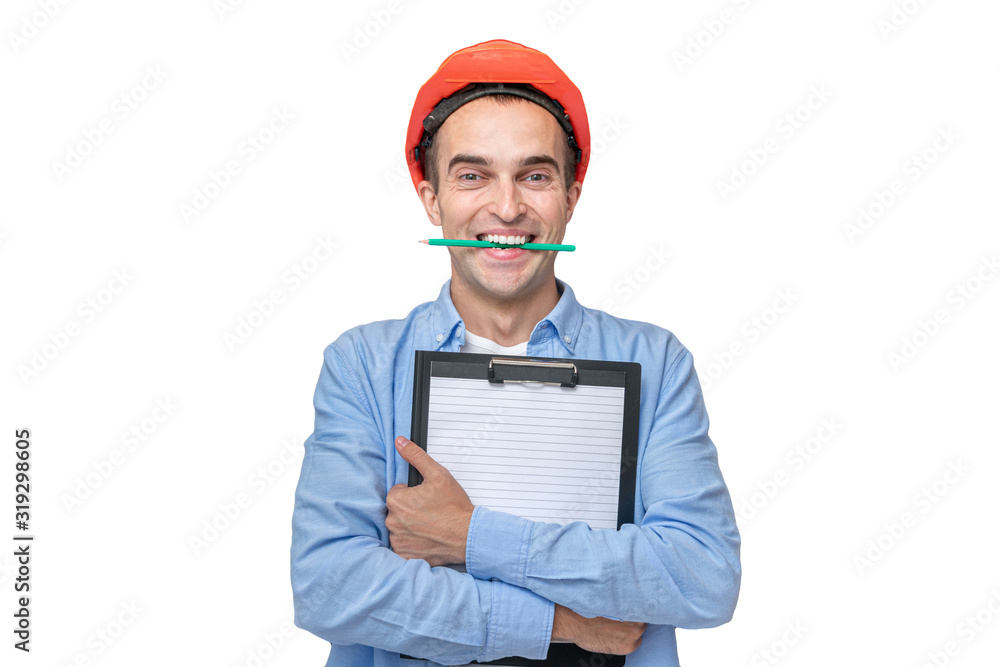 Happy builder in hard hat smiling and holding a pencil in his teeth, isolated background, copying space Happy builder in hard hat smiling and holding a pencil in his teeth, isolated background, copying space