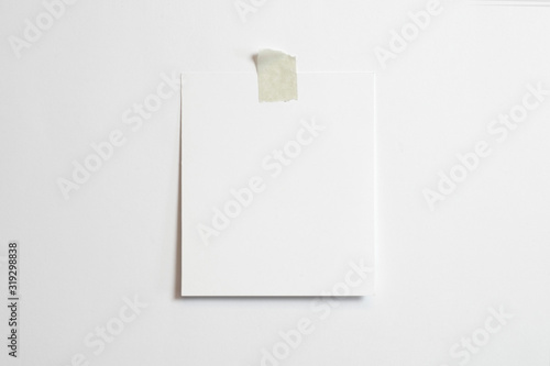 Blank polaroid photo frame with soft shadows  and scotch tape isolated on white paper background as template for graphic designers presentations, portfolios etc.
