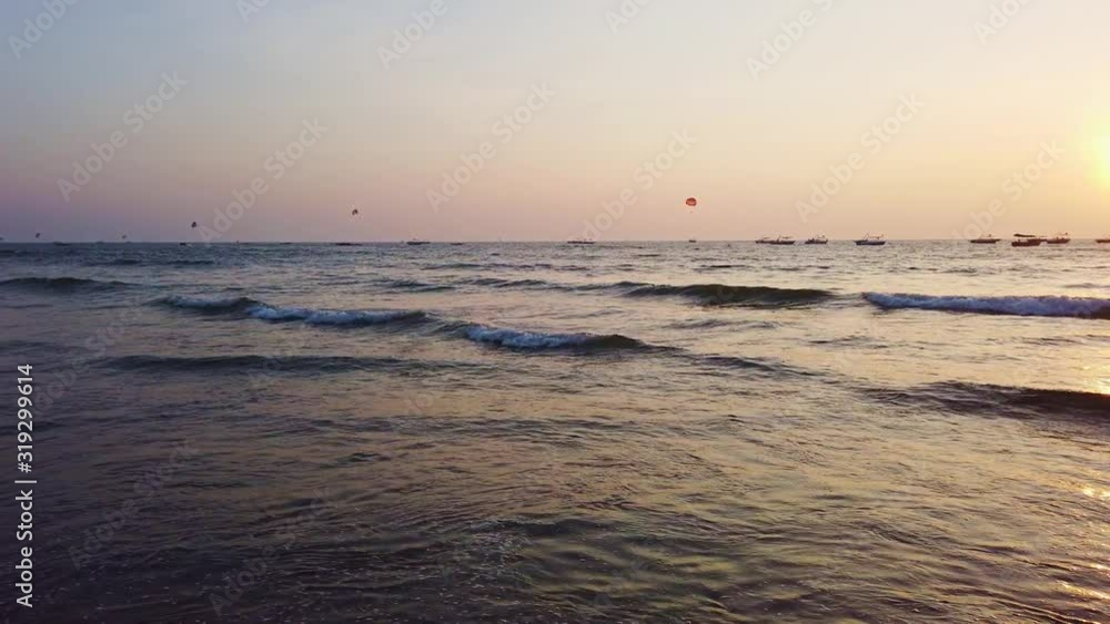 paratroopers and pleasure boats at sea during sunset paratroopers and pleasure boats at sea during sunset