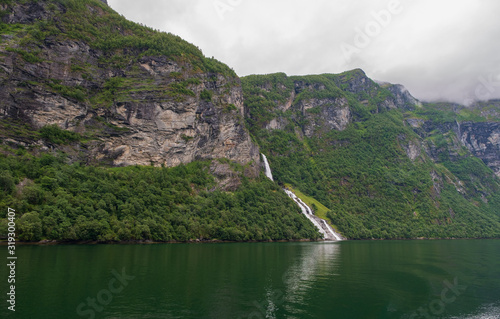 Waterfall over the Geiranger fjord  Norway. July 2019