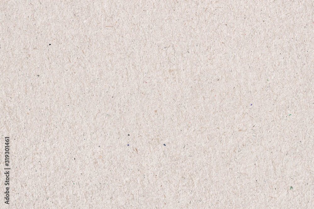 Fototapeta premium Organic cardboard texture close-up. Grunge old paper surface texture. Recyclable material, has small inclusions of cellulose, various villi, fluff