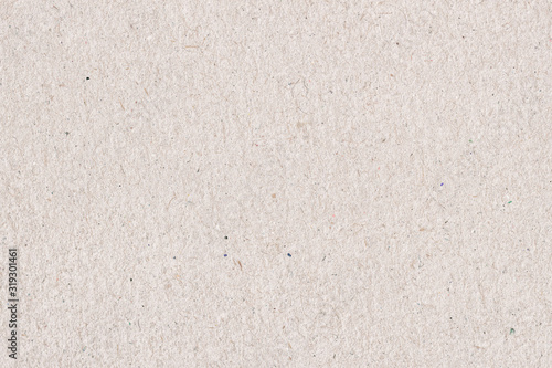 Organic cardboard texture close-up. Grunge old paper surface texture. Recyclable material, has small inclusions of cellulose, various villi, fluff