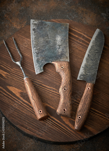 Stylish Butcher's Set: cleaver, knife and fork. Top view photo