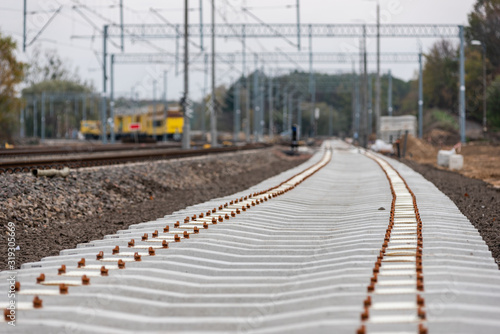 Modernization of the railway line. New track, crushed stone, railway sleepers - close-up