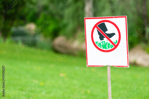 Sign prohibited to walk at grass lawn, close-up.