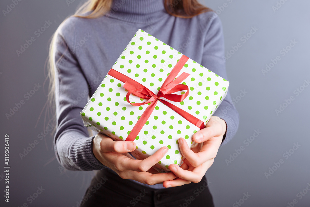Close up view of hands are giving a beautiful gift box to you, female giving gift, presents and greeting season concept Close up view of hands are giving a beautiful gift box to you, female giving gift, presents and greeting season concept