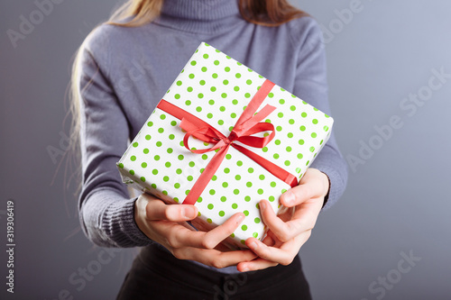 Close up view of hands are giving a beautiful gift box to you, female giving gift, presents and greeting season concept © lightscience