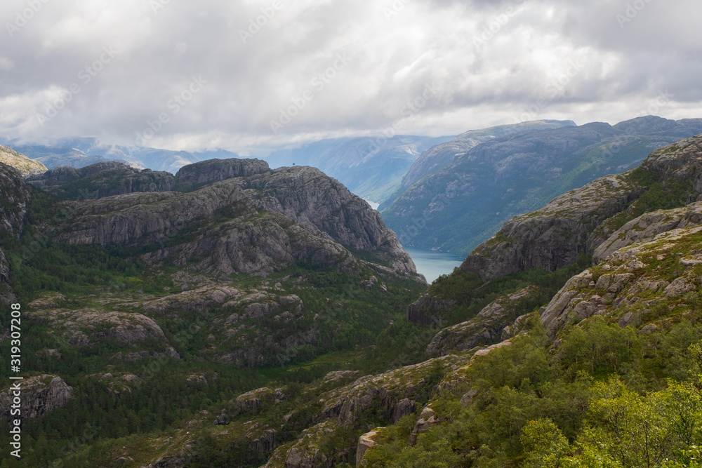 Preikestolen massive cliff Norway, Lysefjorden summer morning view . Beautiful natural vacation hiking walking travel to nature destinations concept. July 2019