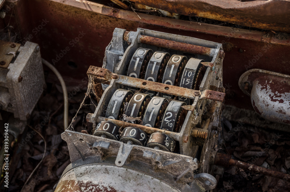 A broken rusted iron counter in an industrial setting A broken rusted iron counter in an industrial setting