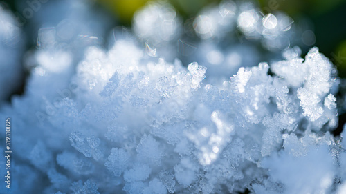 Fresh winter snow closeup of crystals. Shallow depth of field. Winter background