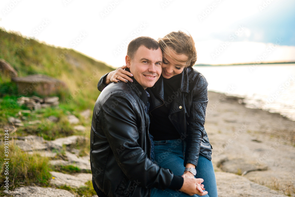 couple sitting on the lake and laughing