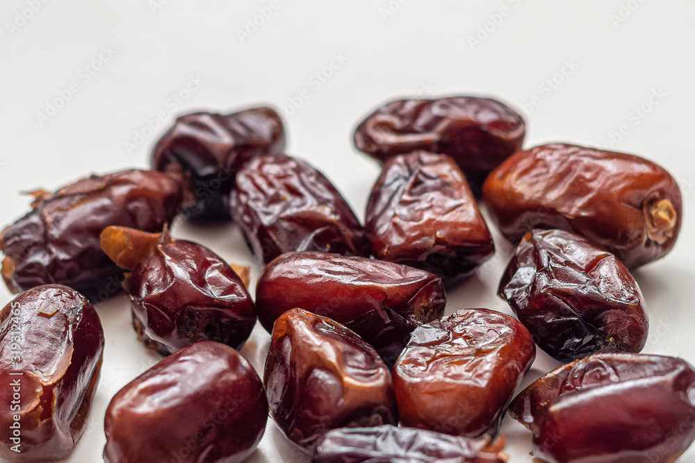 Macro photography of dried dates, with wrinkled brown skin Macro photography of dried dates, with wrinkled brown skin