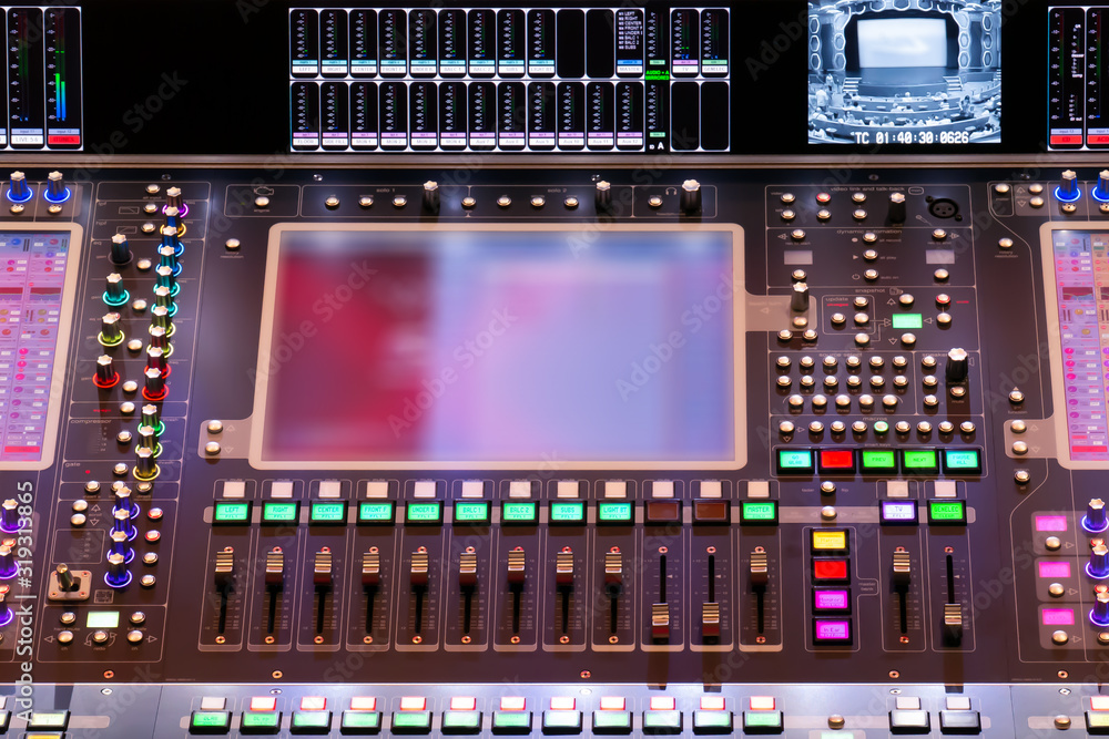 Fototapeta premium Director console with copy space. Controlling panel with numerous illuminated control element, that is used at concerts and other shows with empty screen for your image or copy space.