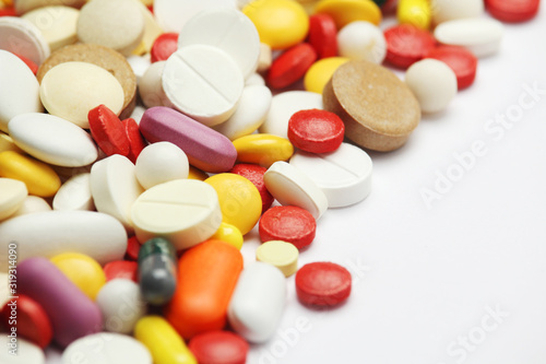 Different colorful tablets at white background 