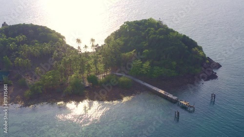 abandoned pier next to coconut grove on deserted beach