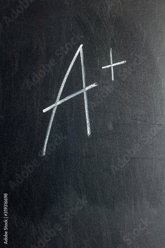 Grade A + written on chalk board
