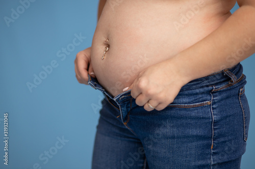 Thick belly of a woman 30-33 years old, does not fit in jeans