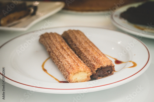 Churros stuffed with chocolate and cream in Madrid, typical spanish dessert