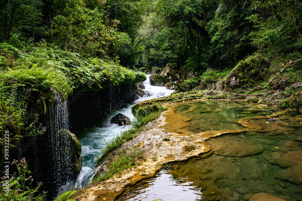Cahabón River disappearing underneath of the limestone rocks at Semuc Champey, a natural monument in the department of Alta Verapaz, Guatemala. Cahabón River disappearing underneath of the limestone rocks at Semuc Champey, a natural monument in the department of Alta Verapaz, Guatemala.