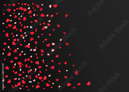 Red hearts confetti on black background.