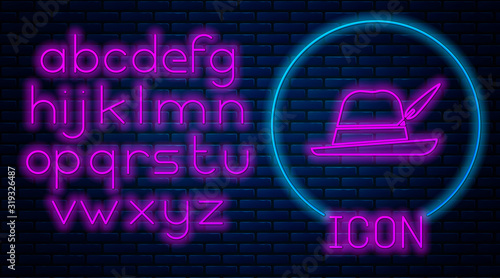 Glowing neon Oktoberfest hat icon isolated on brick wall background. Hunter hat with feather. German hat. Neon light alphabet. Vector Illustration
