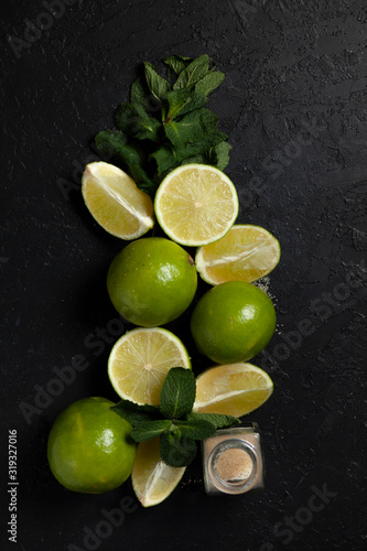 ingredients for making mojito on a dark background, lime, mint, with tools, flat lay for a mojito recipe