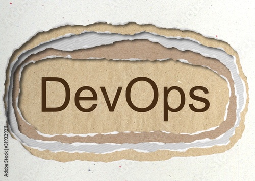 DevOps - word in ragged paper hole background -software development and information-technology operations - concept tattered illustration photo