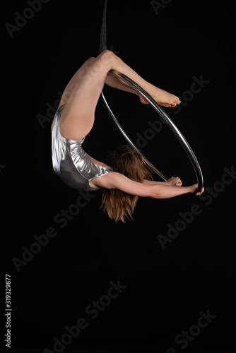 Brunette acrobat on a lyra
