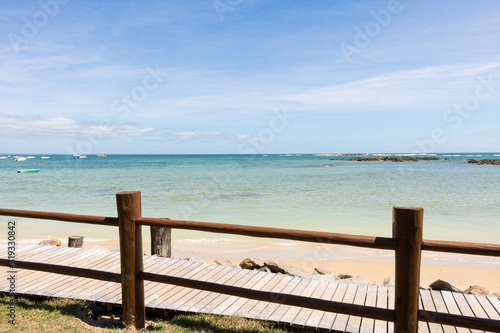 View of deserted beach and wooden deck. Blue Ocean Background. Brazil. Bahia. Morro de Sao Paulo.