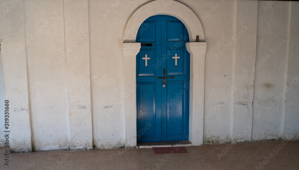 Naklejka premium Blue door to the Church, a door with Christian crosses