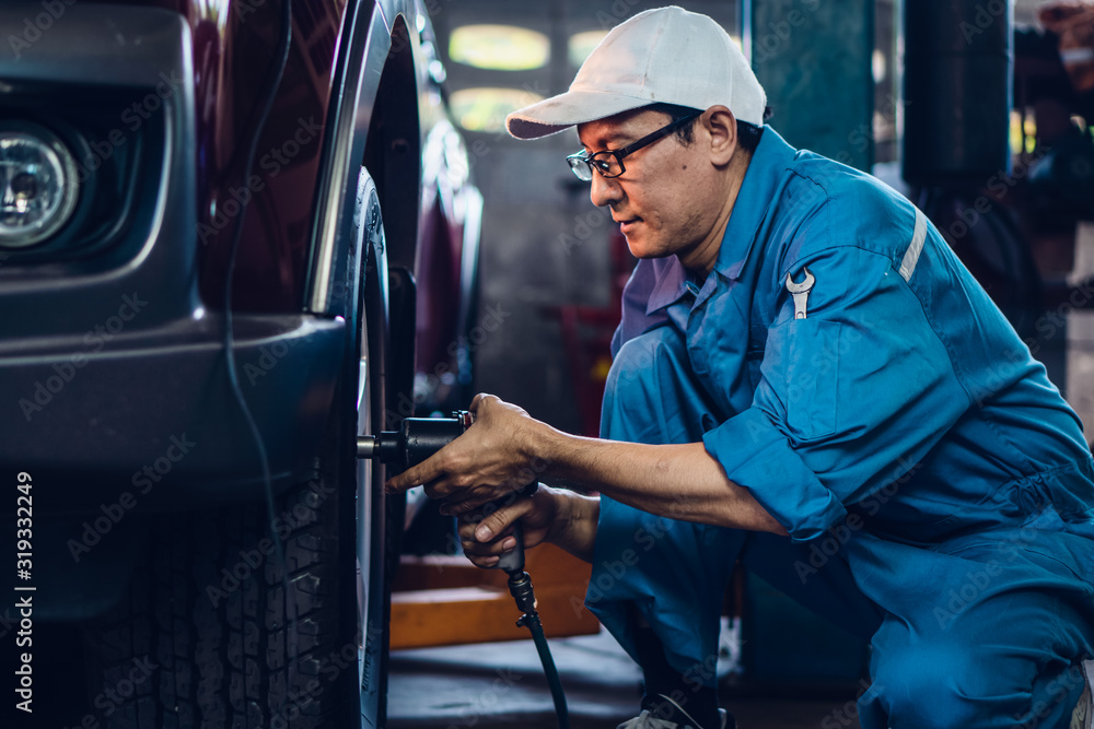 car mechanic checking and repair customer car at garage and maitenance station car mechanic checking and repair customer car at garage and maitenance station