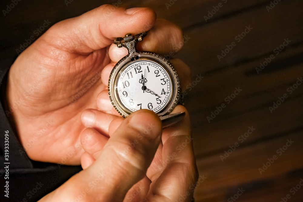 a pocket watch in the hands of a man a pocket watch in the hands of a man