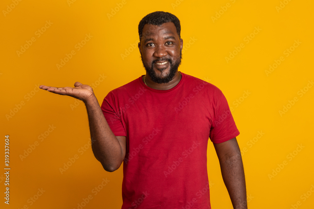 Positive dark skinned male has joyful expression and broad smile with white teeth, being in good mood, isolated over yellow studio wall with copy space. Brazilian middle aged guy. Positive dark skinned male has joyful expression and broad smile with white teeth, being in good mood, isolated over yellow studio wall with copy space. Brazilian middle aged guy.