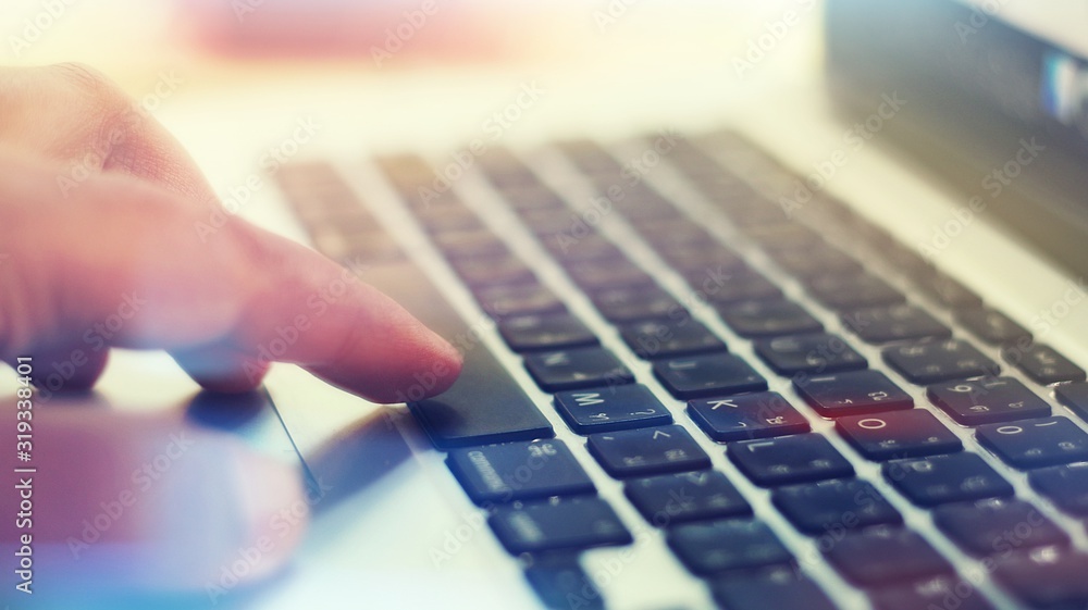 Fototapeta premium hands typing on laptop keyboard