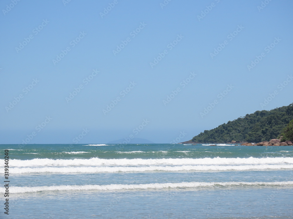 Sea, sand, mountains, sun and blue sky. Beach in the city of Ubatuba. Interior of São Paulo. Brazil. Sea, sand, mountains, sun and blue sky. Beach in the city of Ubatuba. Interior of São Paulo. Brazil.