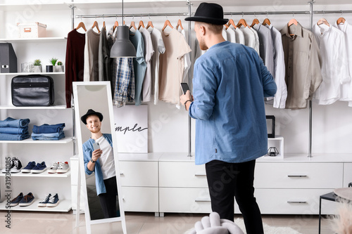 Handsome man trying on styl...