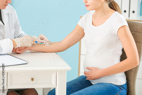 Doctor vaccinating pregnant...