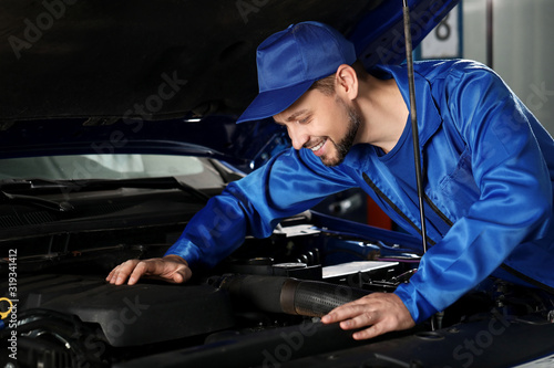 Male mechanic working in car service center