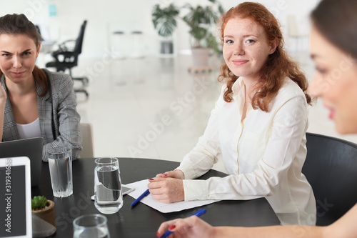 Young businesswoman during meeting in office